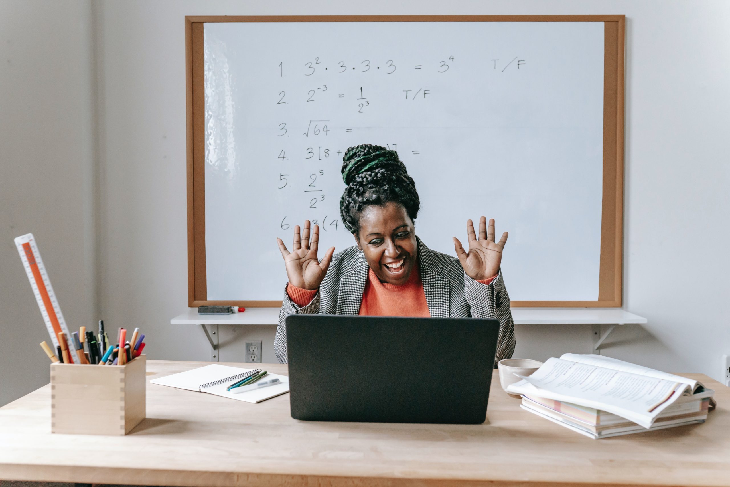 Happy black woman using laptop for online work